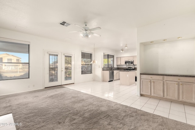 20435 N 39th Dr, Glendale, AZ 85308 - unfurnished living room featuring light colored carpet, visible vents, light tile patterned floors, and a healthy amount of sunlight