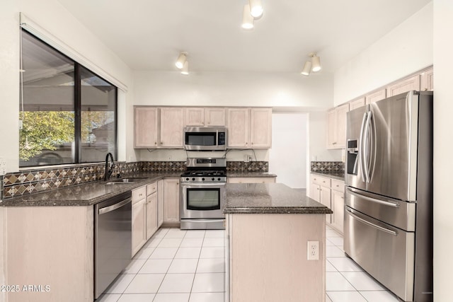 20435 N 39th Dr, Glendale, AZ 85308 - kitchen with light tile patterned floors, dark stone counters, a kitchen island, a sink, and appliances with stainless steel finishes