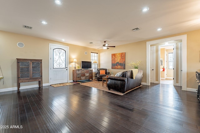 living room with ceiling fan and dark hardwood / wood-style flooring