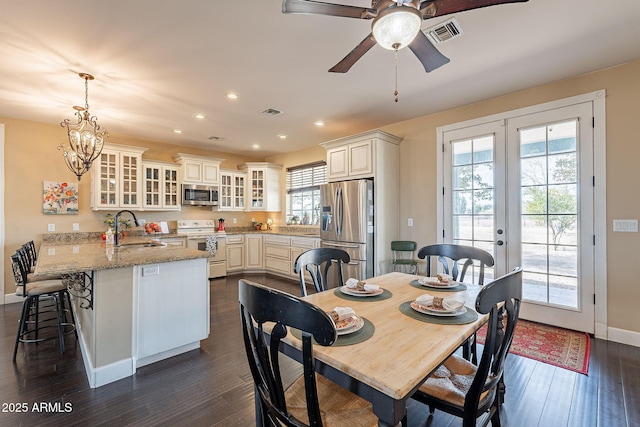 dining room featuring plenty of natural light, sink, dark hardwood / wood-style flooring, and french doors