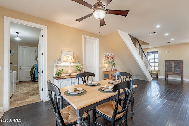 dining room featuring dark wood-type flooring, washer and clothes dryer, and ceiling fan