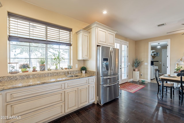 kitchen with stainless steel fridge with ice dispenser, dark hardwood / wood-style floors, cream cabinets, and sink