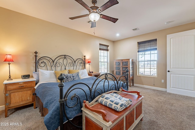 carpeted bedroom with multiple windows and ceiling fan