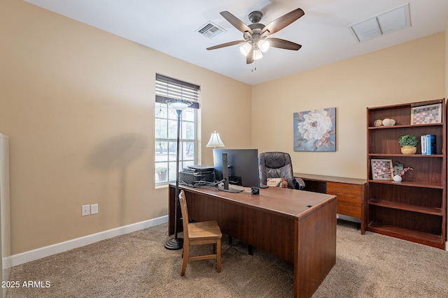 carpeted office space with ceiling fan