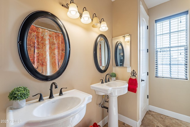 bathroom featuring plenty of natural light and double sink