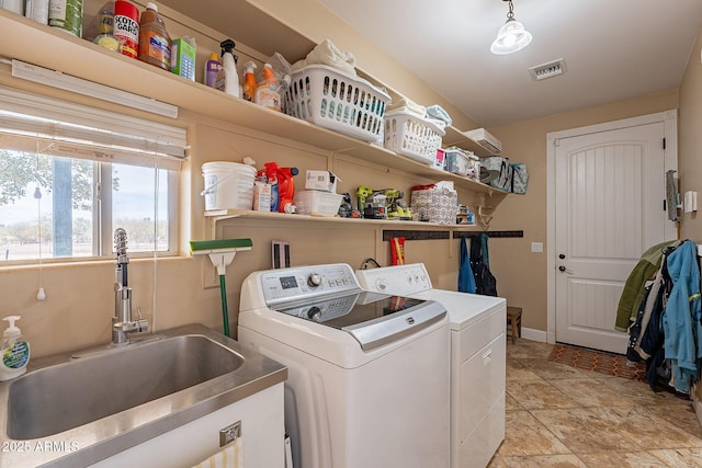 laundry area featuring washing machine and dryer and sink