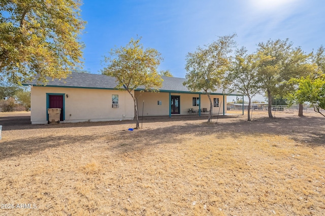 back of house featuring a yard