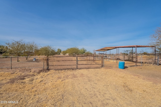 view of yard with a rural view and an outbuilding