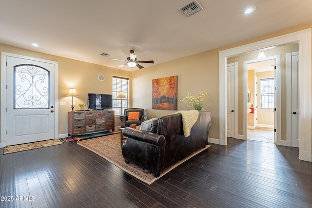 living room featuring dark hardwood / wood-style floors and ceiling fan