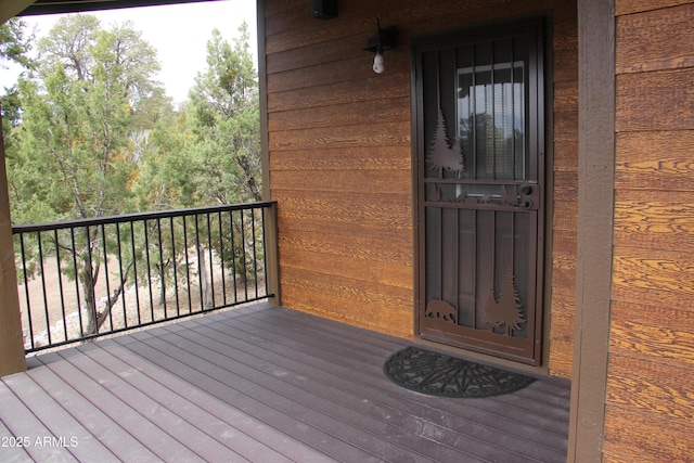 view of exterior entry with a balcony