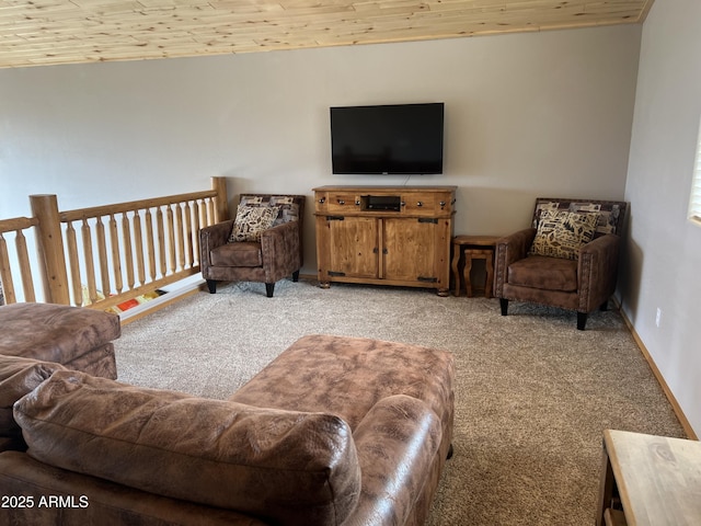living area with baseboards, light colored carpet, and wooden ceiling