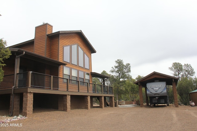 view of property exterior featuring a chimney and driveway