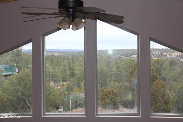 details featuring a wooded view and ceiling fan