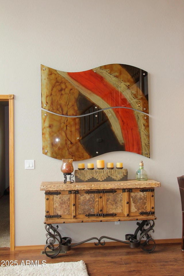 details featuring wood finished floors and baseboards