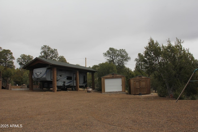view of front facade with an outdoor structure, a detached garage, and a storage unit