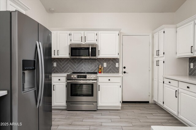 16238 N 58th St, Scottsdale, AZ 85254 - kitchen with stainless steel appliances, light countertops, white cabinets, and backsplash