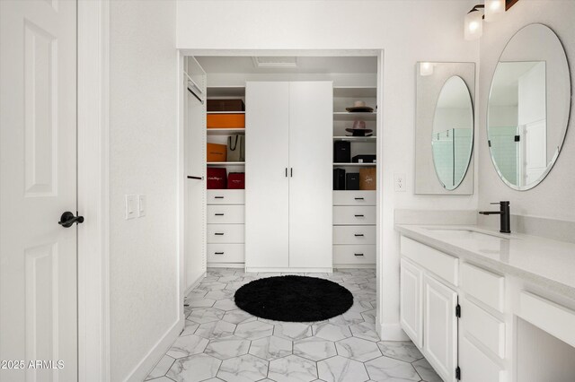 16238 N 58th St, Scottsdale, AZ 85254 - full bathroom featuring vanity, a walk in closet, and marble look tiles