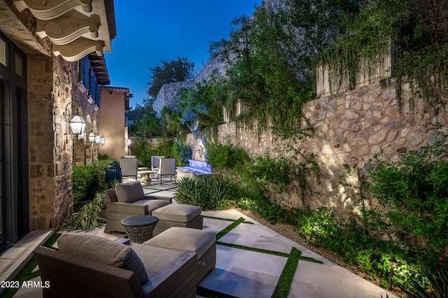 patio at twilight with an outdoor living space