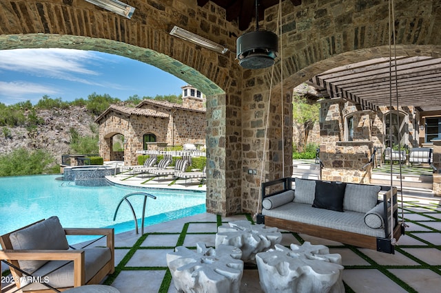 view of swimming pool featuring a patio and an outdoor living space