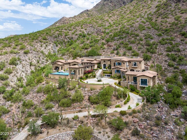 birds eye view of property with a mountain view