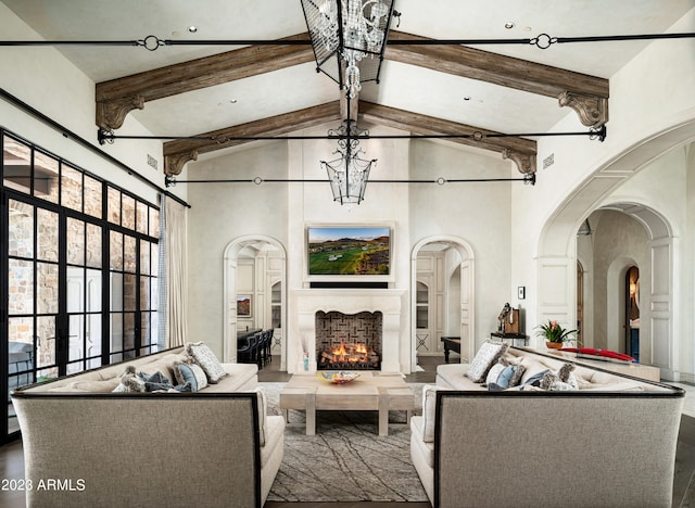 living room with high vaulted ceiling, a chandelier, and beamed ceiling