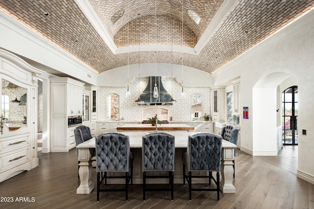 interior space featuring brick ceiling, ornamental molding, dark hardwood / wood-style flooring, and vaulted ceiling