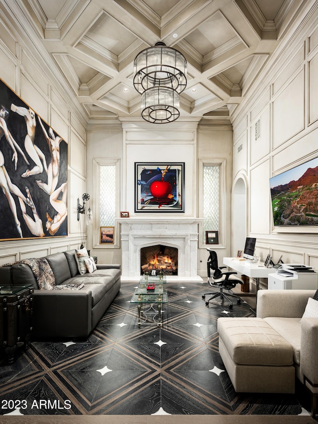 living room featuring crown molding, coffered ceiling, a high end fireplace, and a notable chandelier