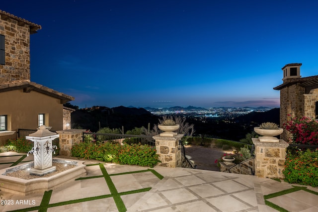 patio terrace at dusk with a mountain view