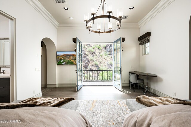 bedroom with a notable chandelier, ornamental molding, dark hardwood / wood-style flooring, and access to exterior