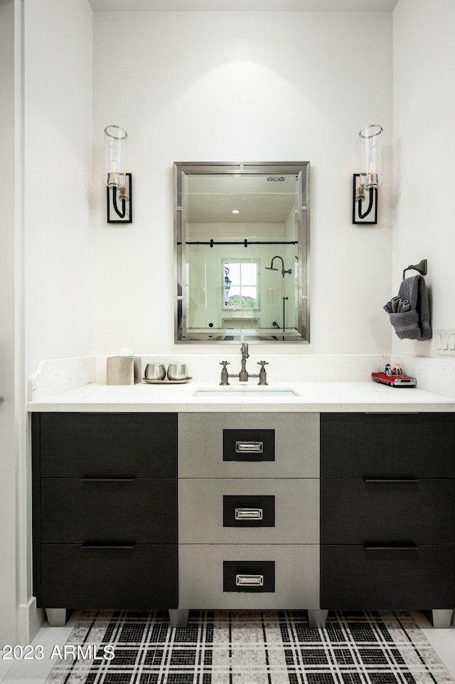 bathroom with vanity, tile patterned flooring, and a shower with door