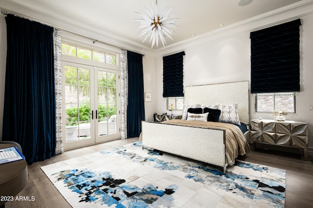 bedroom with crown molding, wood-type flooring, french doors, and access to exterior