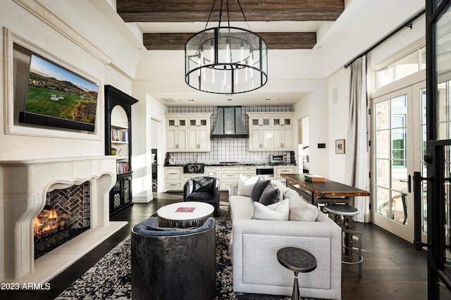 living room with beamed ceiling, plenty of natural light, and dark wood-type flooring