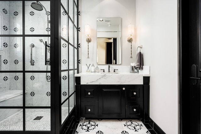 bathroom with vanity, tile patterned flooring, and a tile shower