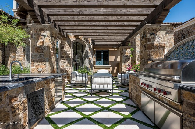 view of patio / terrace with a pergola, area for grilling, sink, and an outdoor kitchen