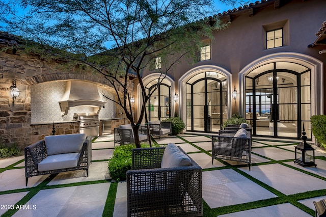 view of patio featuring french doors and exterior kitchen