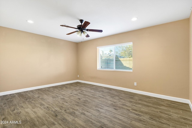 empty room featuring ceiling fan and dark hardwood / wood-style floors