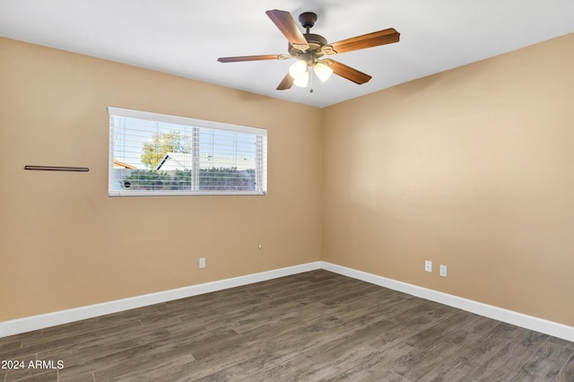 spare room featuring dark hardwood / wood-style flooring and ceiling fan