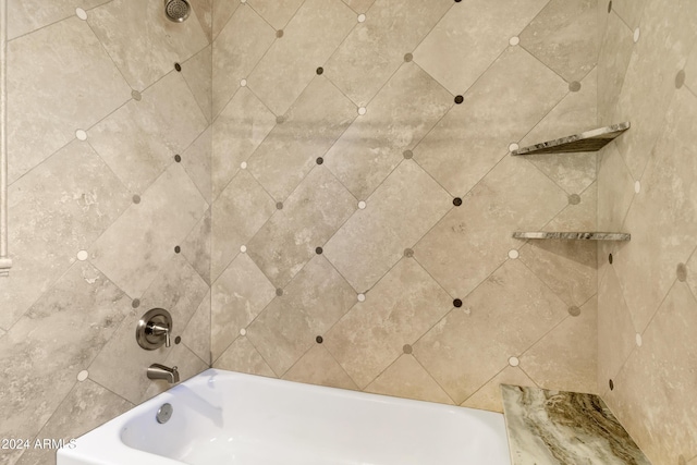 details featuring tiled shower / bath combo