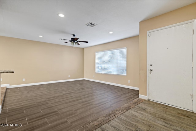 interior space with ceiling fan and dark wood-type flooring