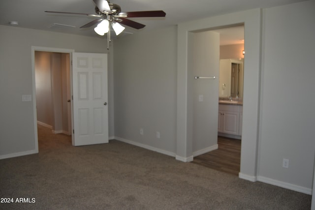 unfurnished bedroom featuring connected bathroom, carpet flooring, and ceiling fan