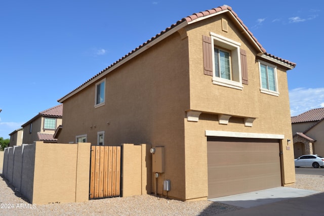 view of side of home featuring a garage