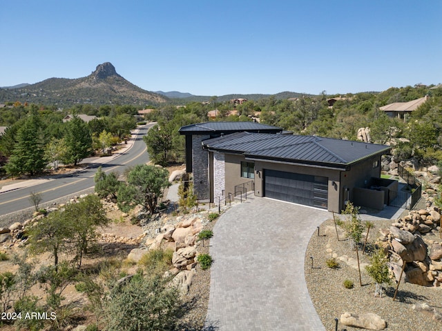 view of front of property with a garage and a mountain view