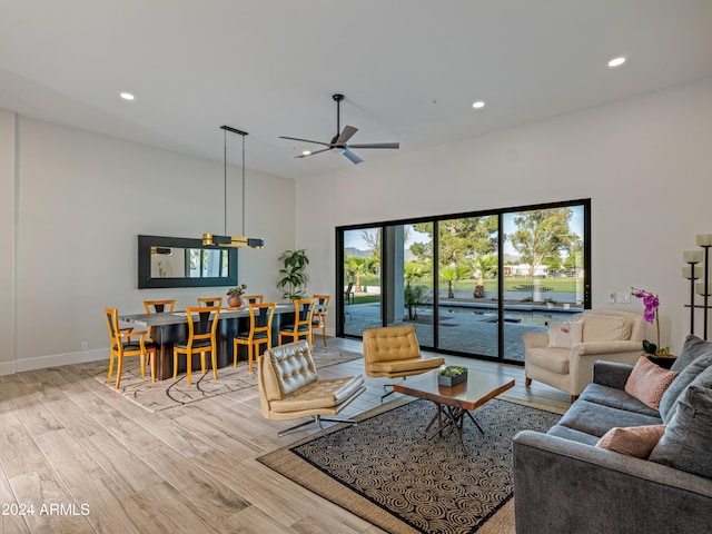 living room with light hardwood / wood-style floors and ceiling fan