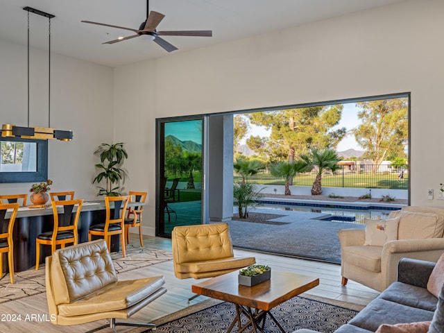 living room with ceiling fan and light wood-type flooring