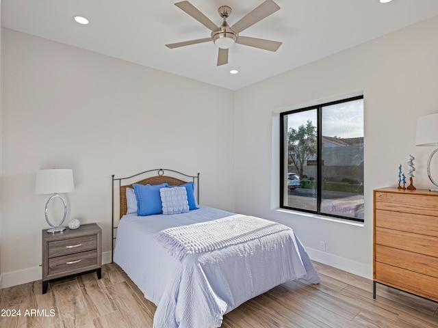 bedroom with light wood-type flooring and ceiling fan