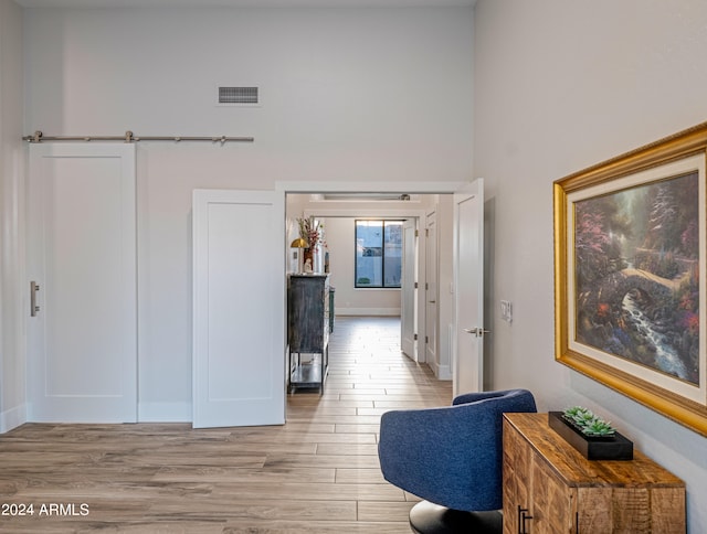 hall with light hardwood / wood-style floors