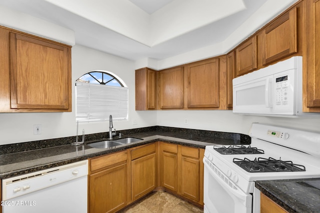 10030 W Indian School Rd Unit 218, Phoenix, AZ 85037 - kitchen with white appliances, brown cabinetry, and dark stone countertops