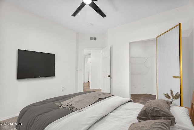 10030 W Indian School Rd Unit 218, Phoenix, AZ 85037 - bedroom with carpet, ceiling fan, a closet, and a walk in closet