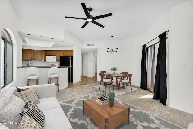 10030 W Indian School Rd Unit 218, Phoenix, AZ 85037 - living area featuring a ceiling fan, light colored carpet, and a tray ceiling
