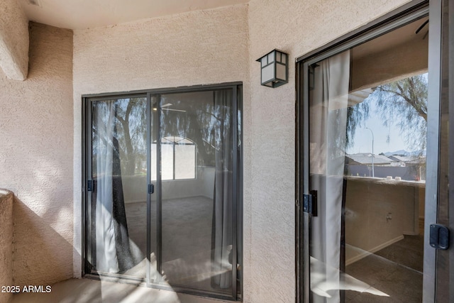 10030 W Indian School Rd Unit 218, Phoenix, AZ 85037 - view of exterior entry with a balcony and stucco siding